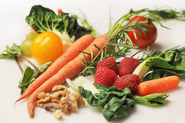 Carrots, walnuts, raspberries, tomatoes, and greens