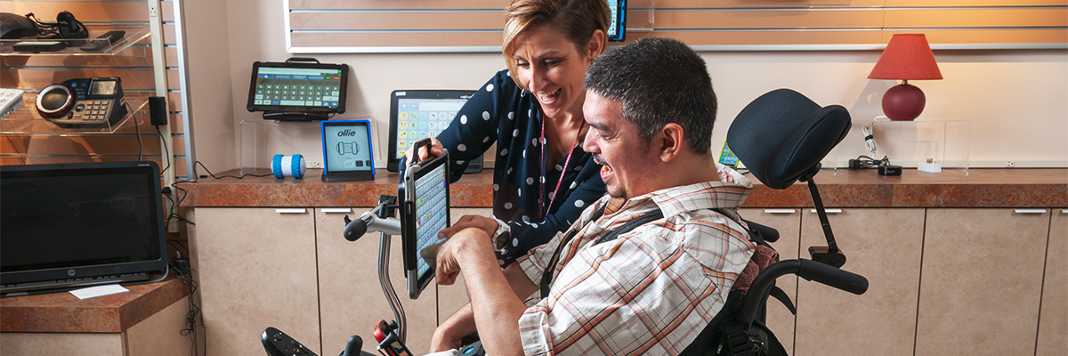 Man uses tablet to communicate with rehabilitation technology specialist