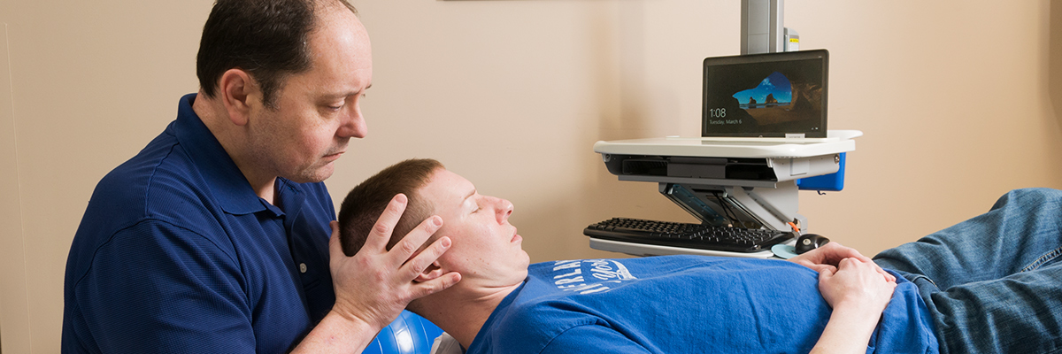 Physical Therapist performing neck stretches on patient