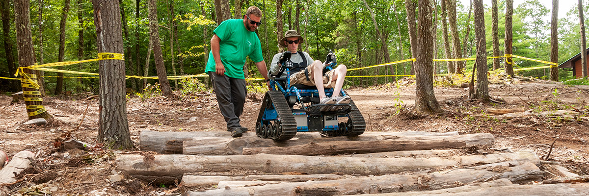 Man in ActionTrack adaptive wheelchair in Off-Roading event at Northeast Off-Road Adventures