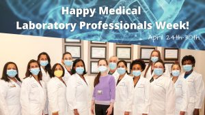 Laboratory professionals and a "Happy Medical Laboratory Professionals Week" banner
