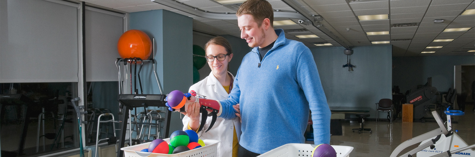 Physical Therapist and Patient holding a ball