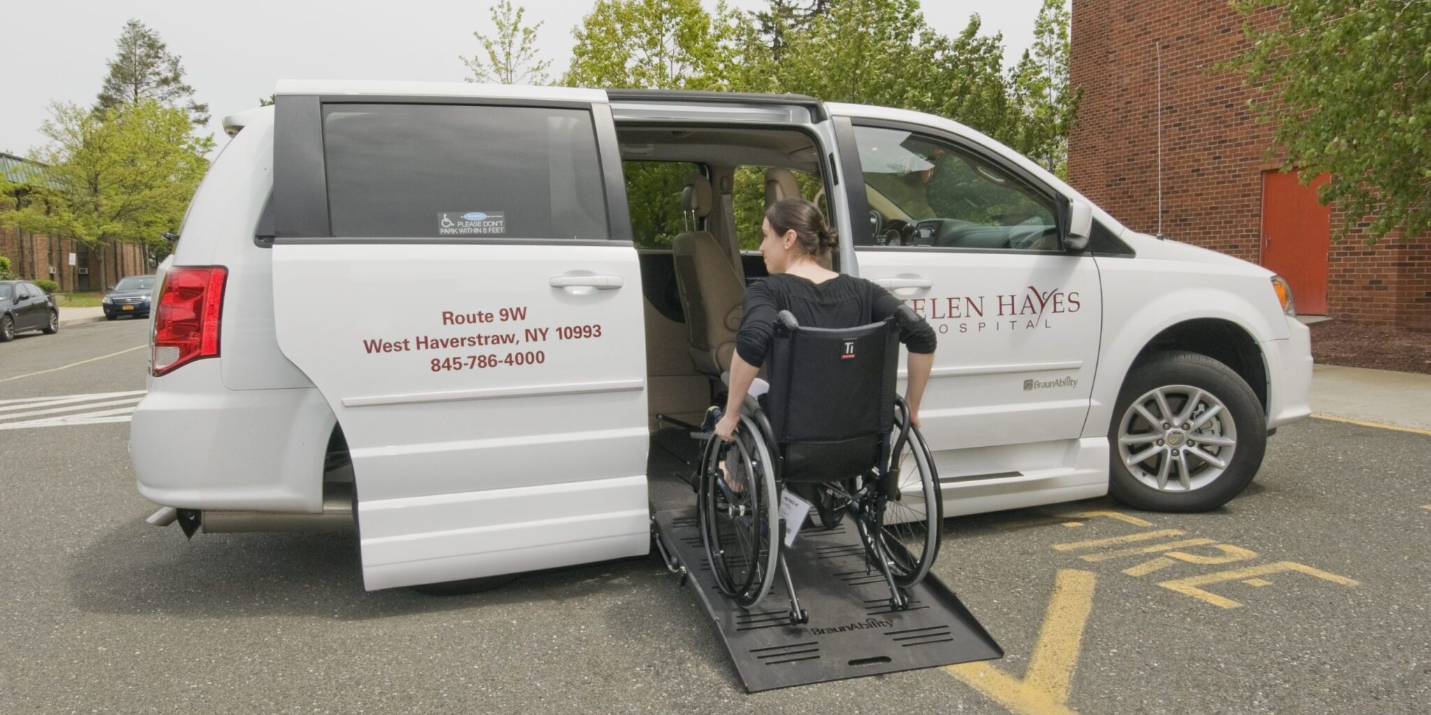 Patient in wheelchair boarding Helen Hayes van on ramp