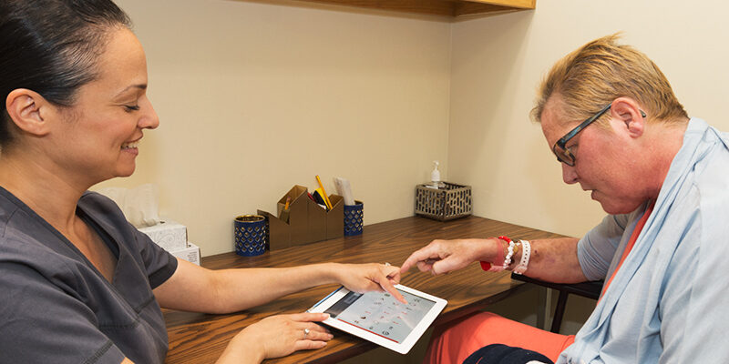 Patient using tablet during occupational therapy session