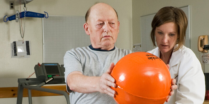 Physical Therapist and patient perform balance exercises for Parkinson's Disease treatment