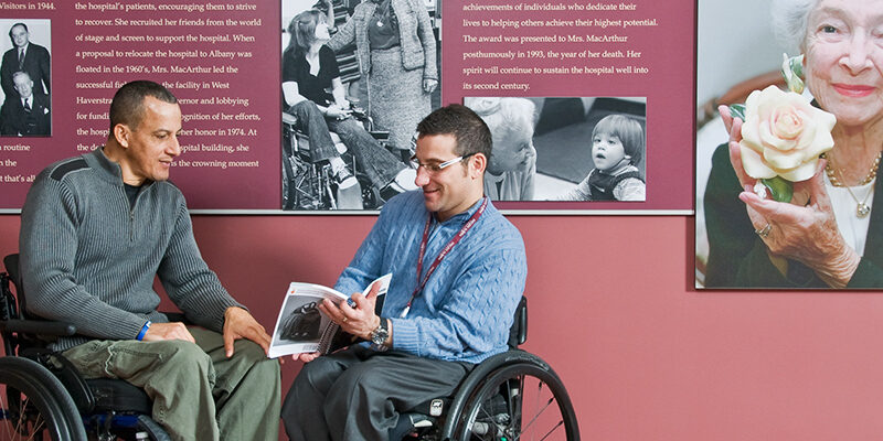Peer mentor talking with patient living with a spinal cord injury